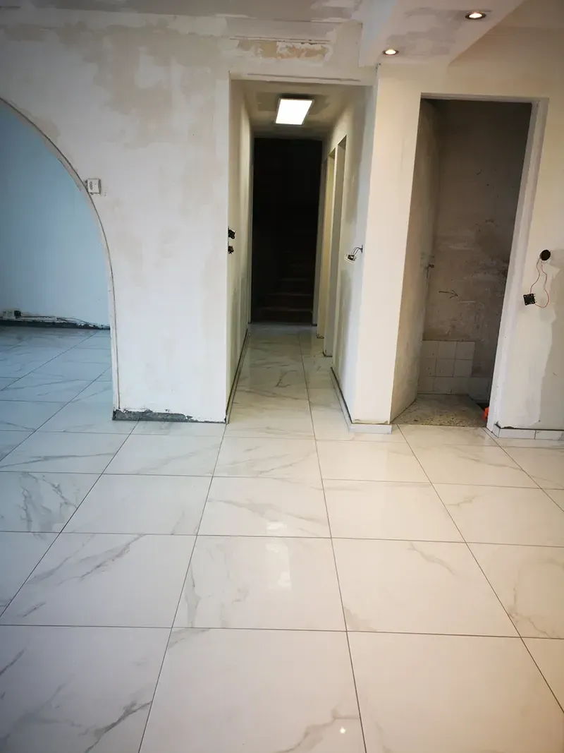 Carrelage effet marbre blanc posé dans une entrée en rénovation